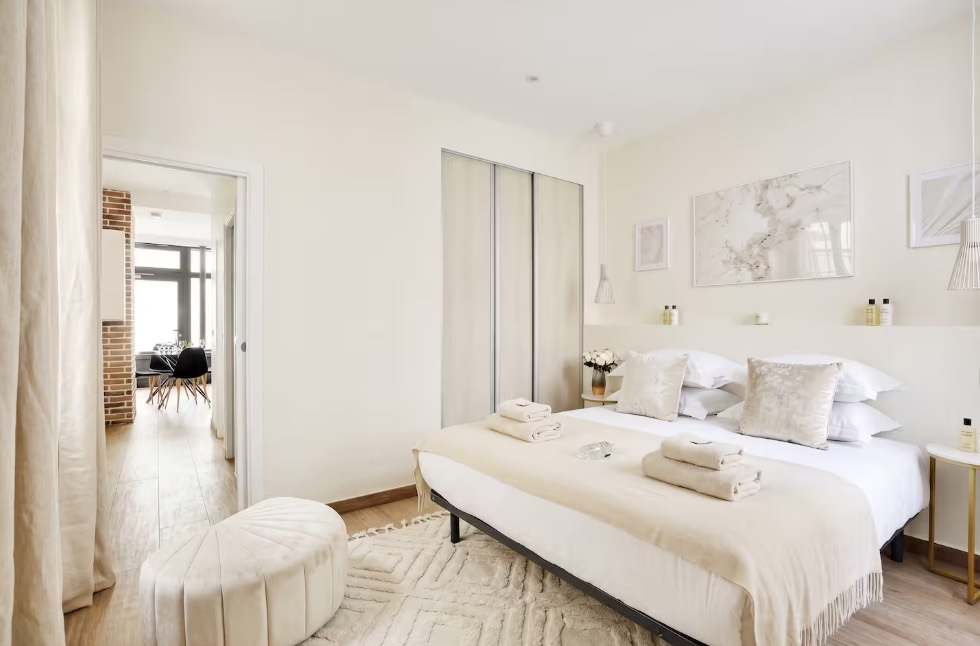 Bright bedroom with white linen and natural light